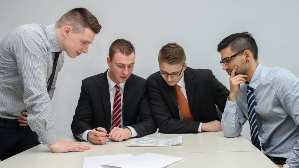 A group of businessmen looking at a document on the table
