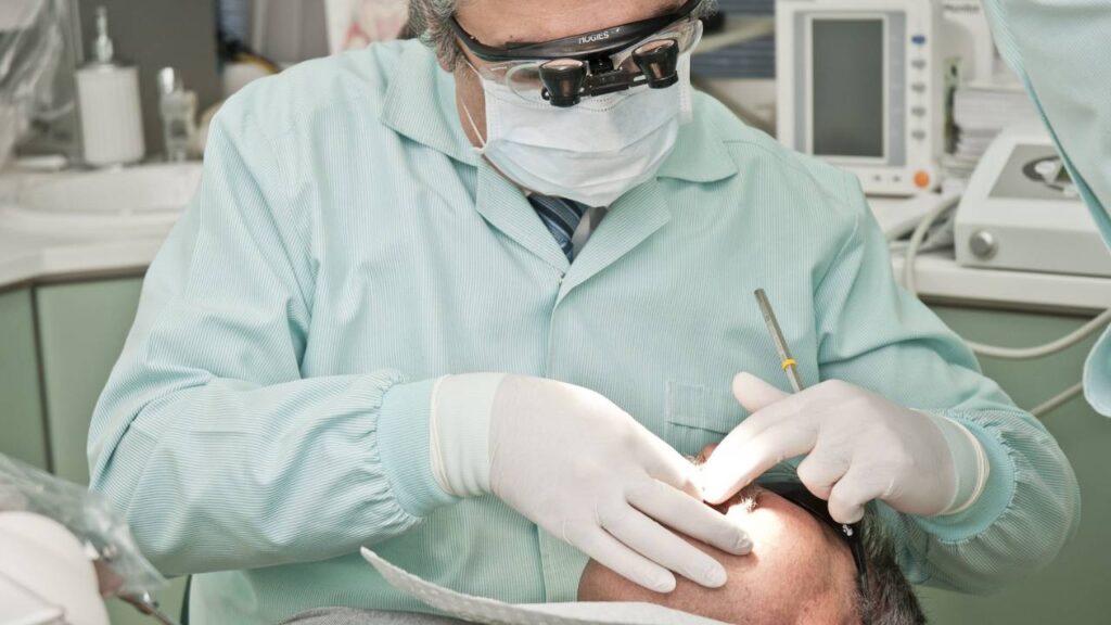 A dentist working on a patient's teeth