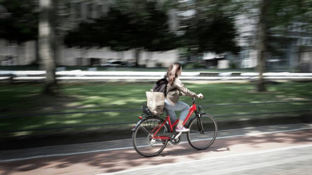 A female employee riding her bicycle to work