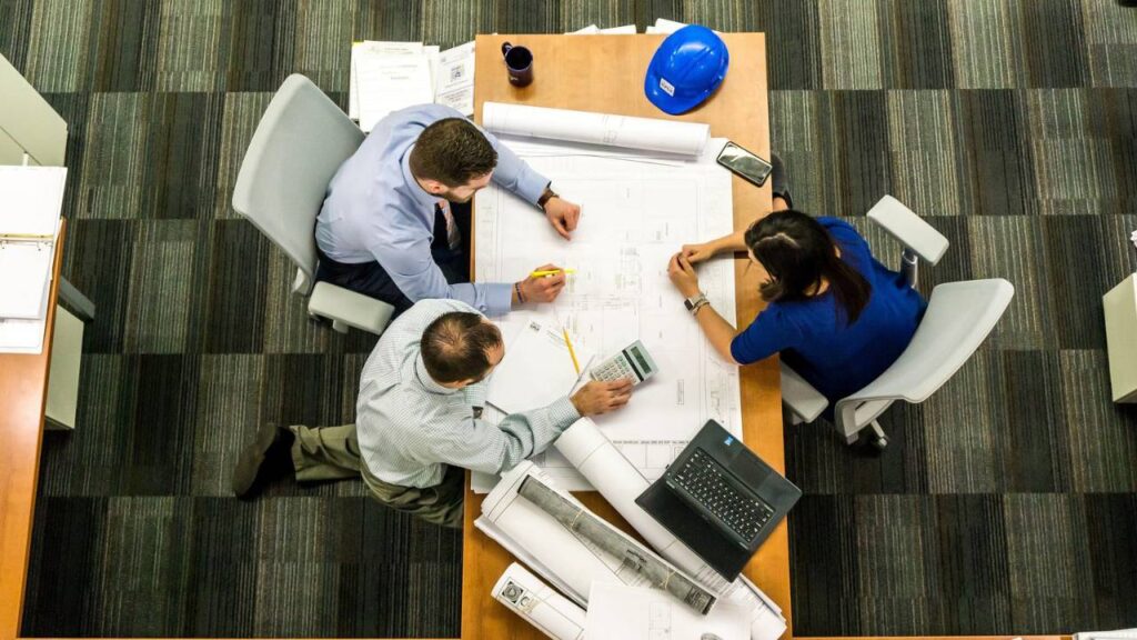 Several employees drawing up a plan in an office setting