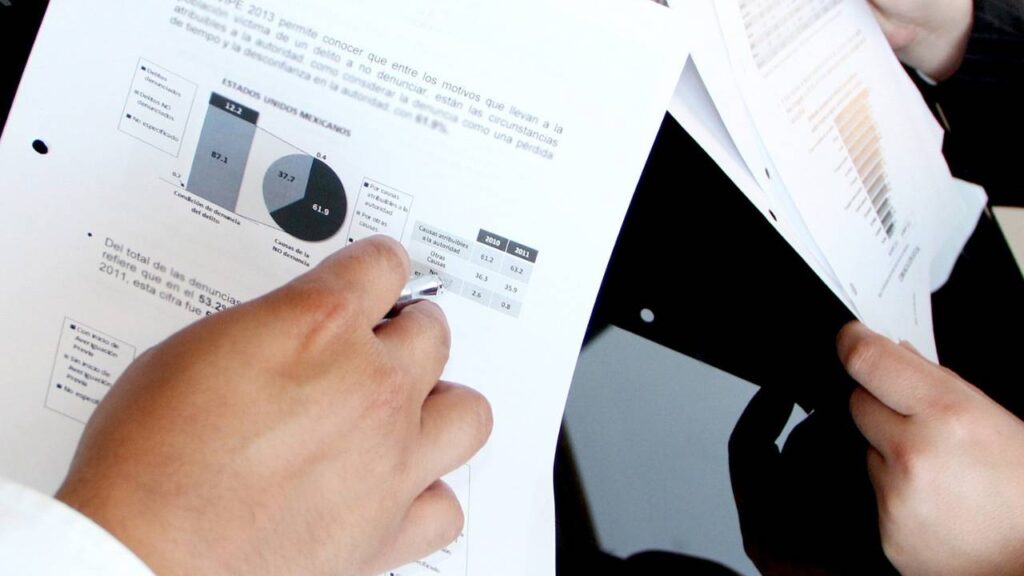 A close-up photo of two people checking important documents 